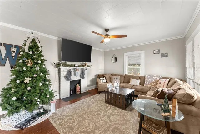 a living room with furniture a flat screen tv and a fireplace