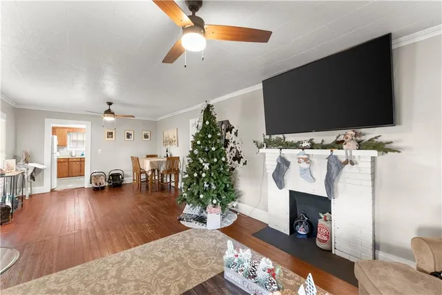 a living room with furniture a flat screen tv and a fireplace