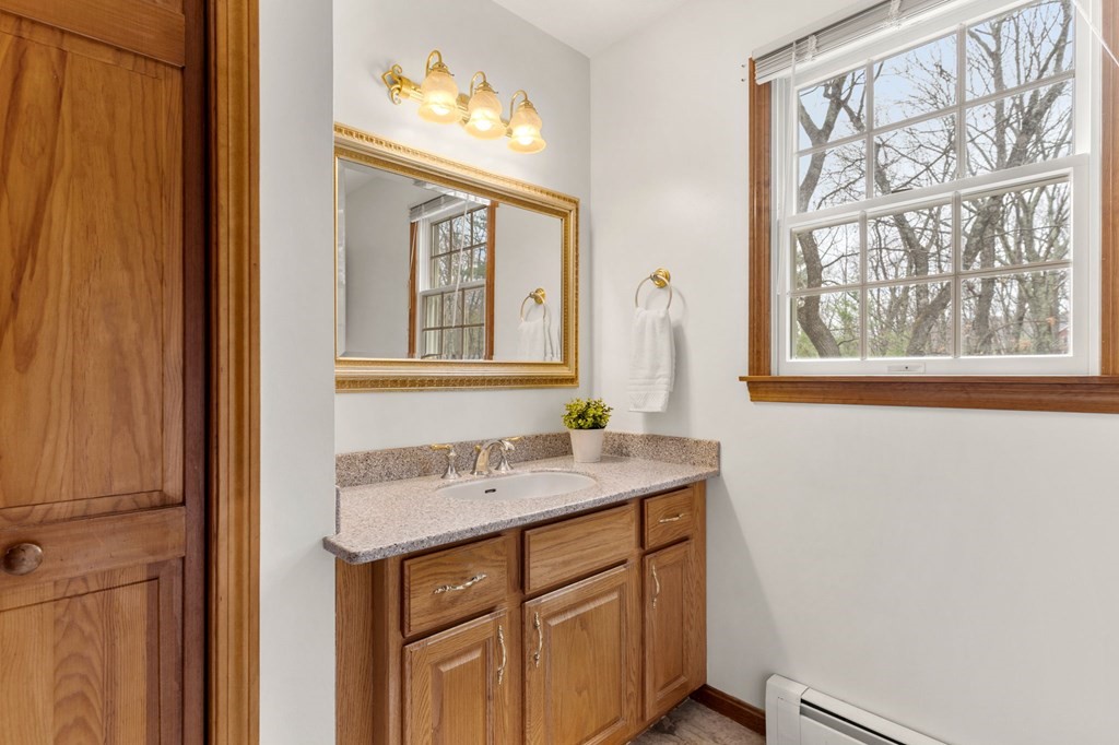 628 Boston Road Groton, MA 01450 - Photo 16 of 32 a bathroom with a sink and a mirror