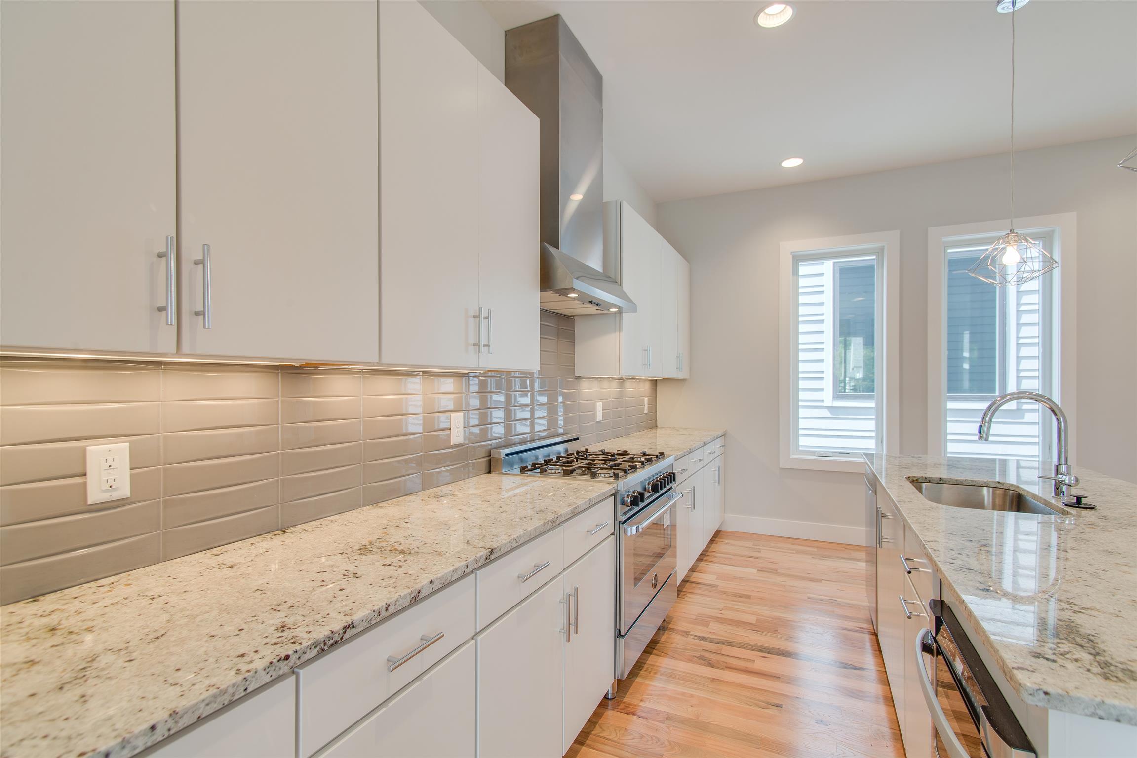 119 A Rains Avenue Nashville, TN 37203 - Photo 11 of 25 a kitchen with stainless steel appliances granite countertop a stove and a sink