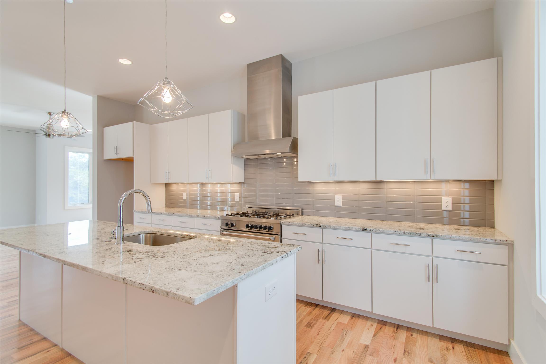 119 A Rains Avenue Nashville, TN 37203 - Photo 12 of 25 a kitchen with stainless steel appliances granite countertop a sink stove and refrigerator