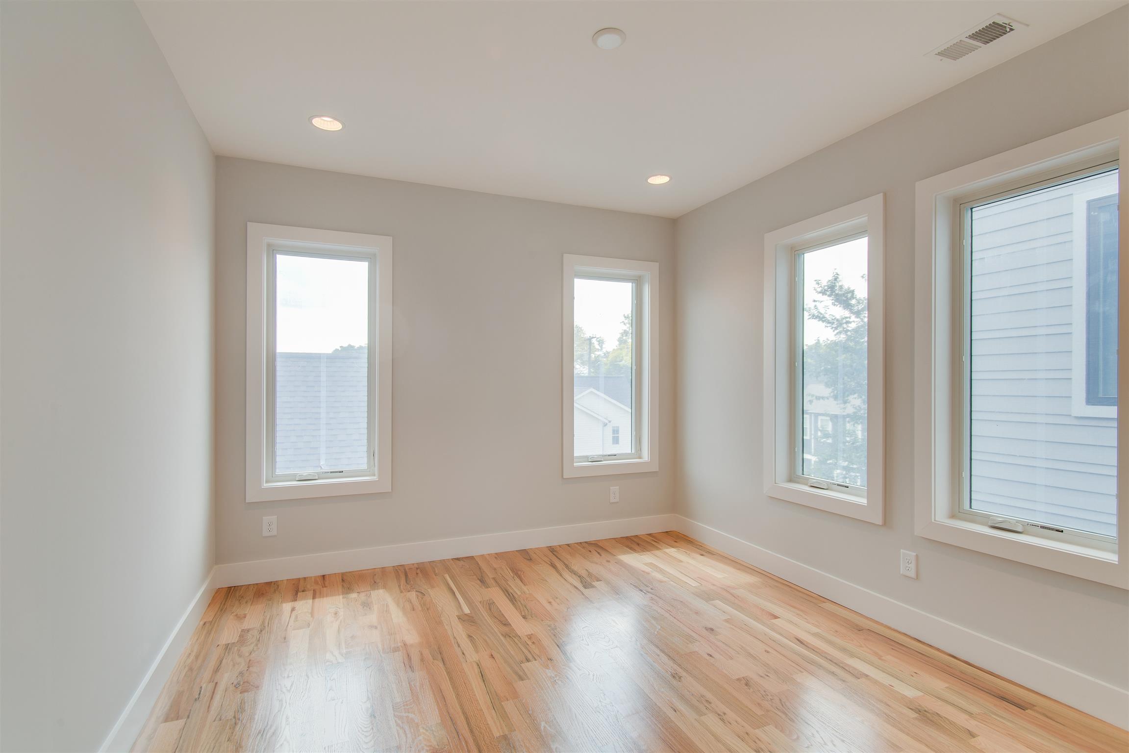 119 A Rains Avenue Nashville, TN 37203 - Photo 15 of 25 an empty room with wooden floor and windows