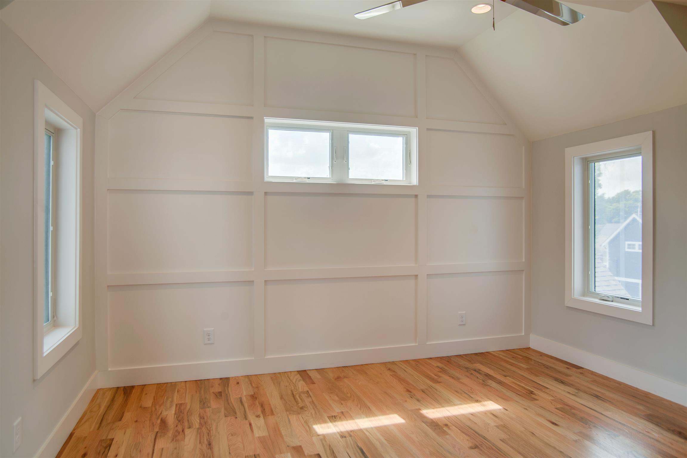 119 A Rains Avenue Nashville, TN 37203 - Photo 17 of 25 an empty room with wooden floor and windows
