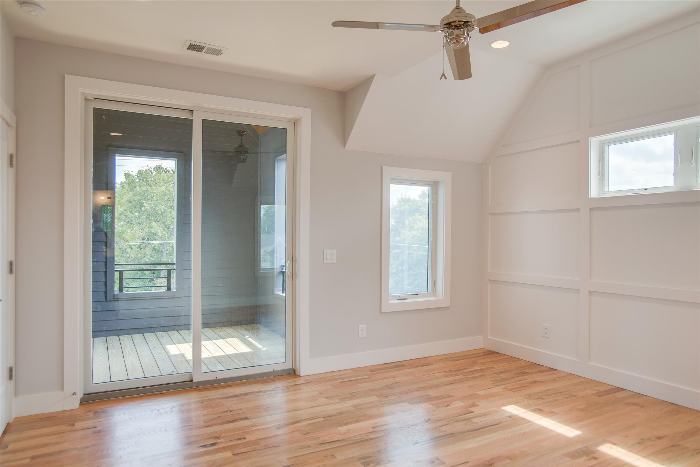 119 A Rains Avenue Nashville, TN 37203 - Photo 18 of 25 an empty room with wooden floor and windows