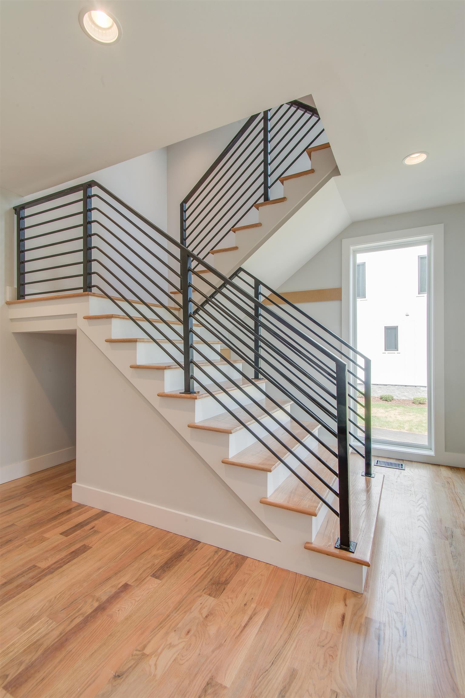 119 A Rains Avenue Nashville, TN 37203 - Photo 3 of 25 a view of a hallway with wooden floor and staircase