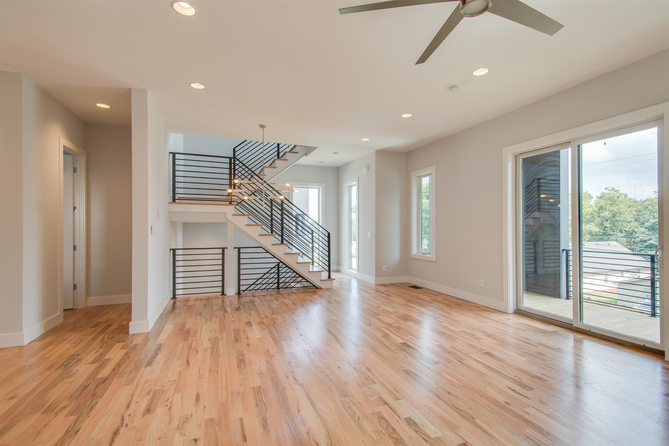 119 A Rains Avenue Nashville, TN 37203 - Photo 6 of 25 an empty room with wooden floor and windows
