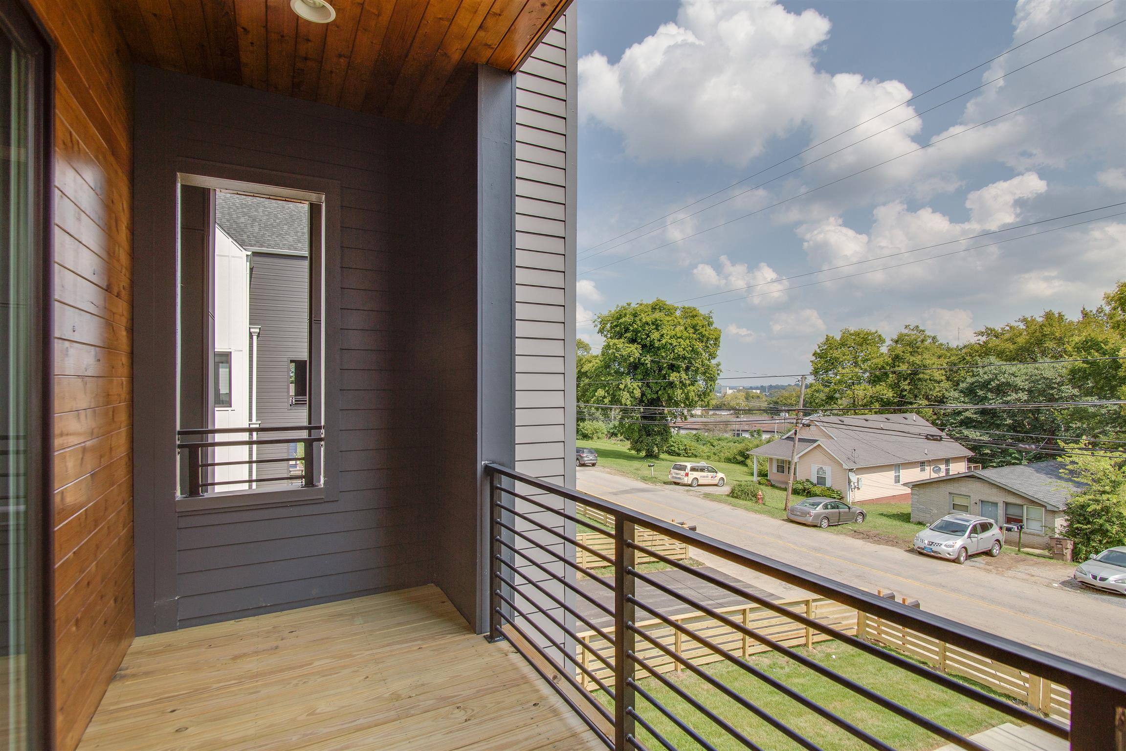 119 A Rains Avenue Nashville, TN 37203 - Photo 7 of 25 a view of a balcony with wooden floor and fence