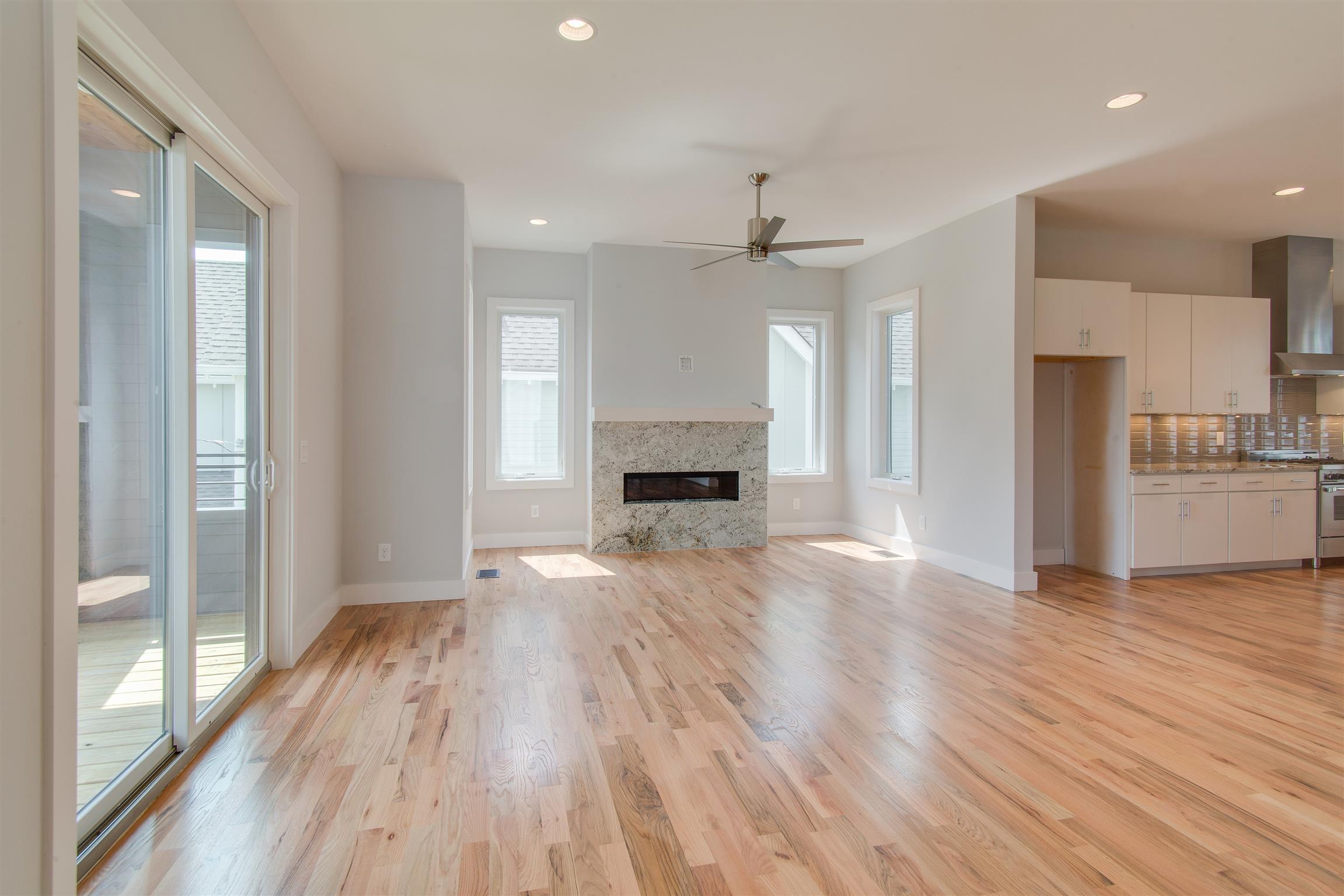 119 A Rains Avenue Nashville, TN 37203 - Photo 8 of 25 a view of a livingroom with a fireplace wooden floor and window