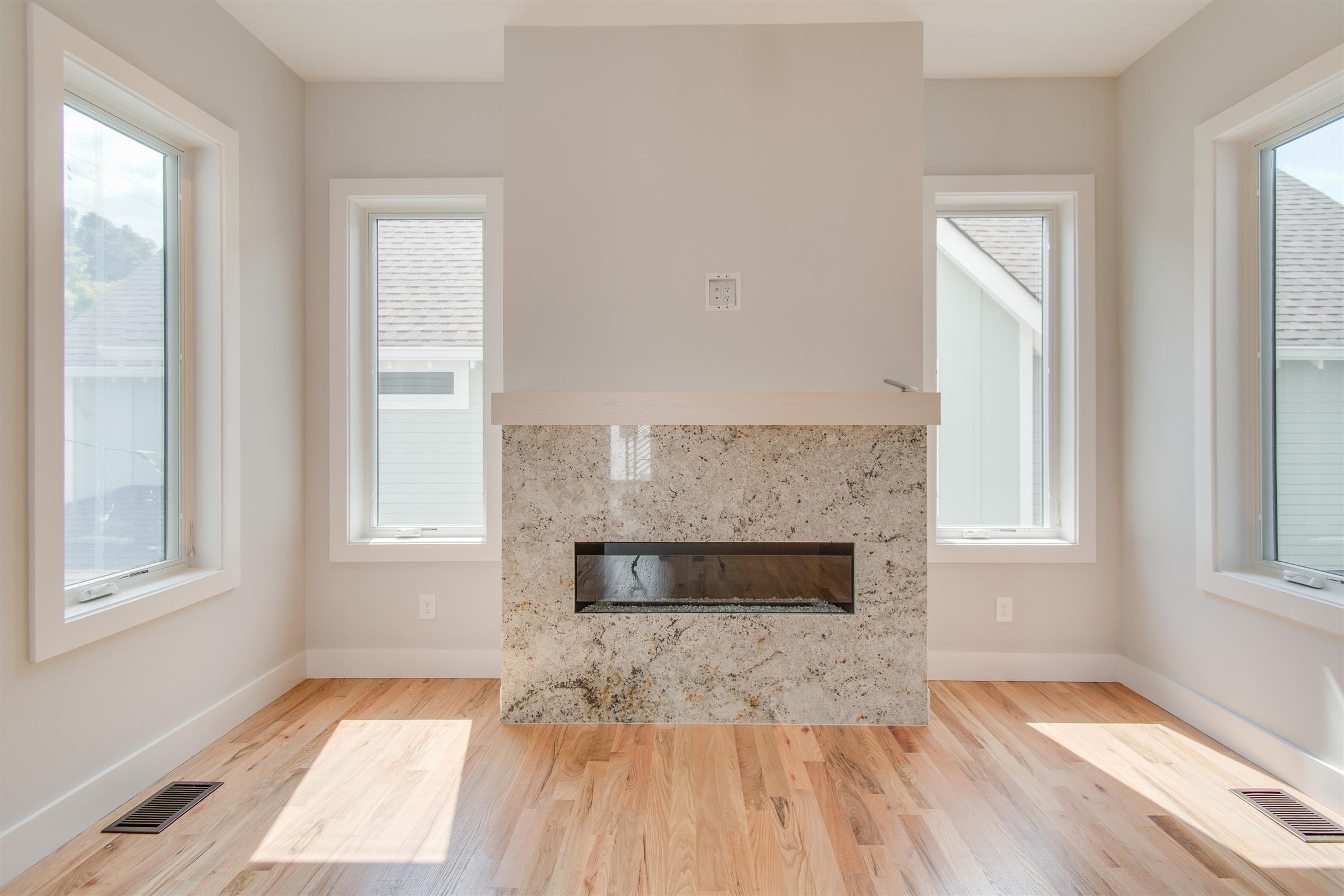 119 A Rains Avenue Nashville, TN 37203 - Photo 9 of 25 an empty room with windows and fireplace