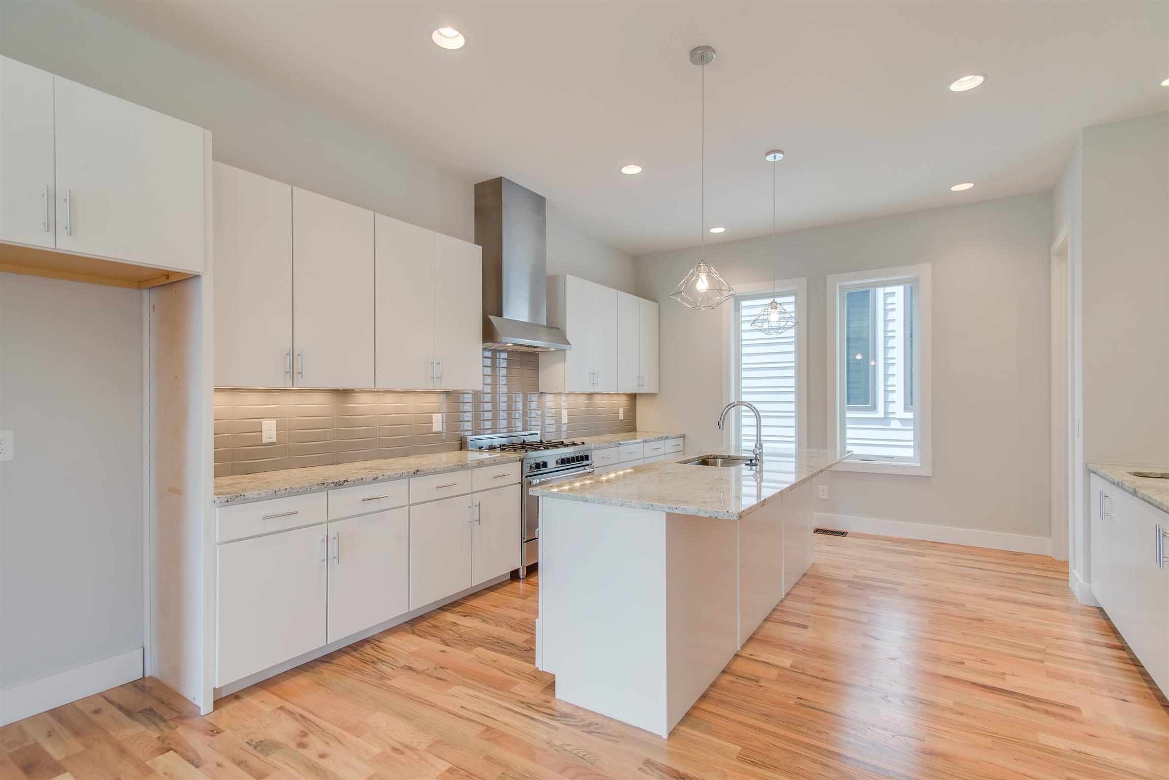 119 A Rains Avenue Nashville, TN 37203 - Photo 10 of 25 a kitchen with a sink stove and cabinets