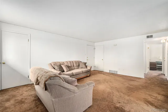 a view of a dining room with furniture and a chandelier