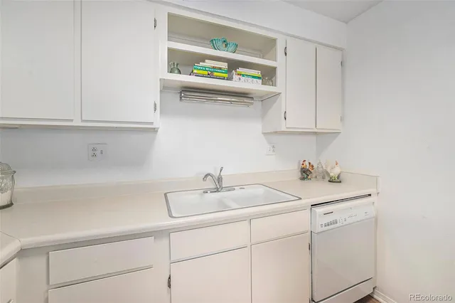 a kitchen with cabinets a stainless steel appliances and refrigerator