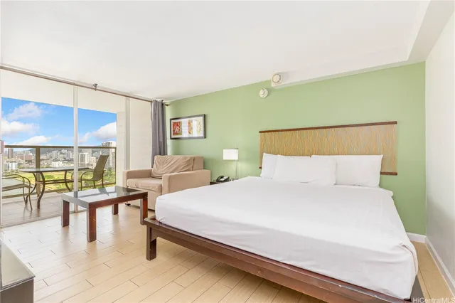 a bedroom with a bed and large windows