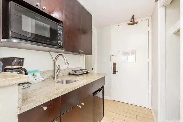 a kitchen with stainless steel appliances a sink a stove and microwave