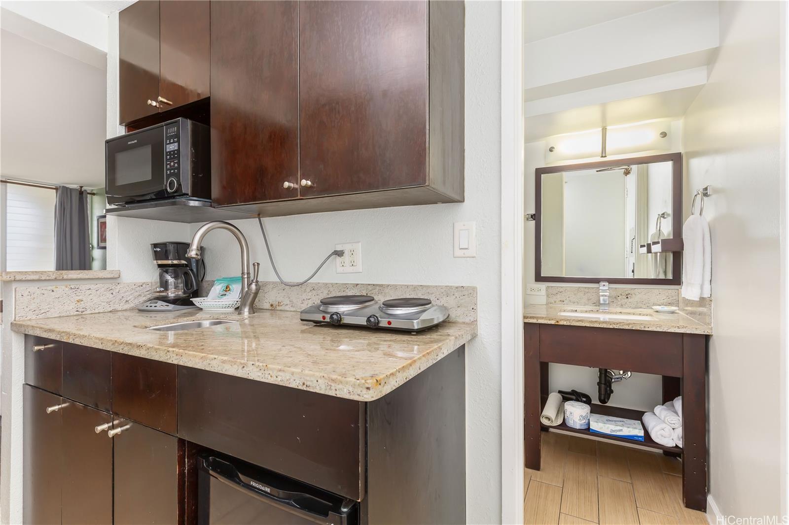 445 Seaside Avenue, Unit 2804 Honolulu, HI 96815 - Photo 14 of 25 a bathroom with a sink and a mirror