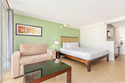 a bedroom with a bed and wooden floor