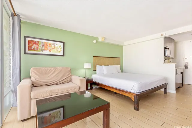 a bedroom with a bed and wooden floor