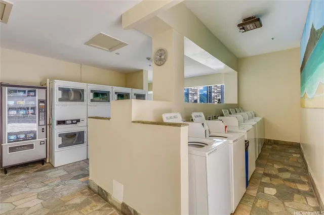 a kitchen with stainless steel appliances granite countertop a refrigerator and a stove