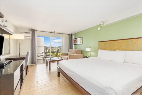 a bedroom with a bed a table and chair