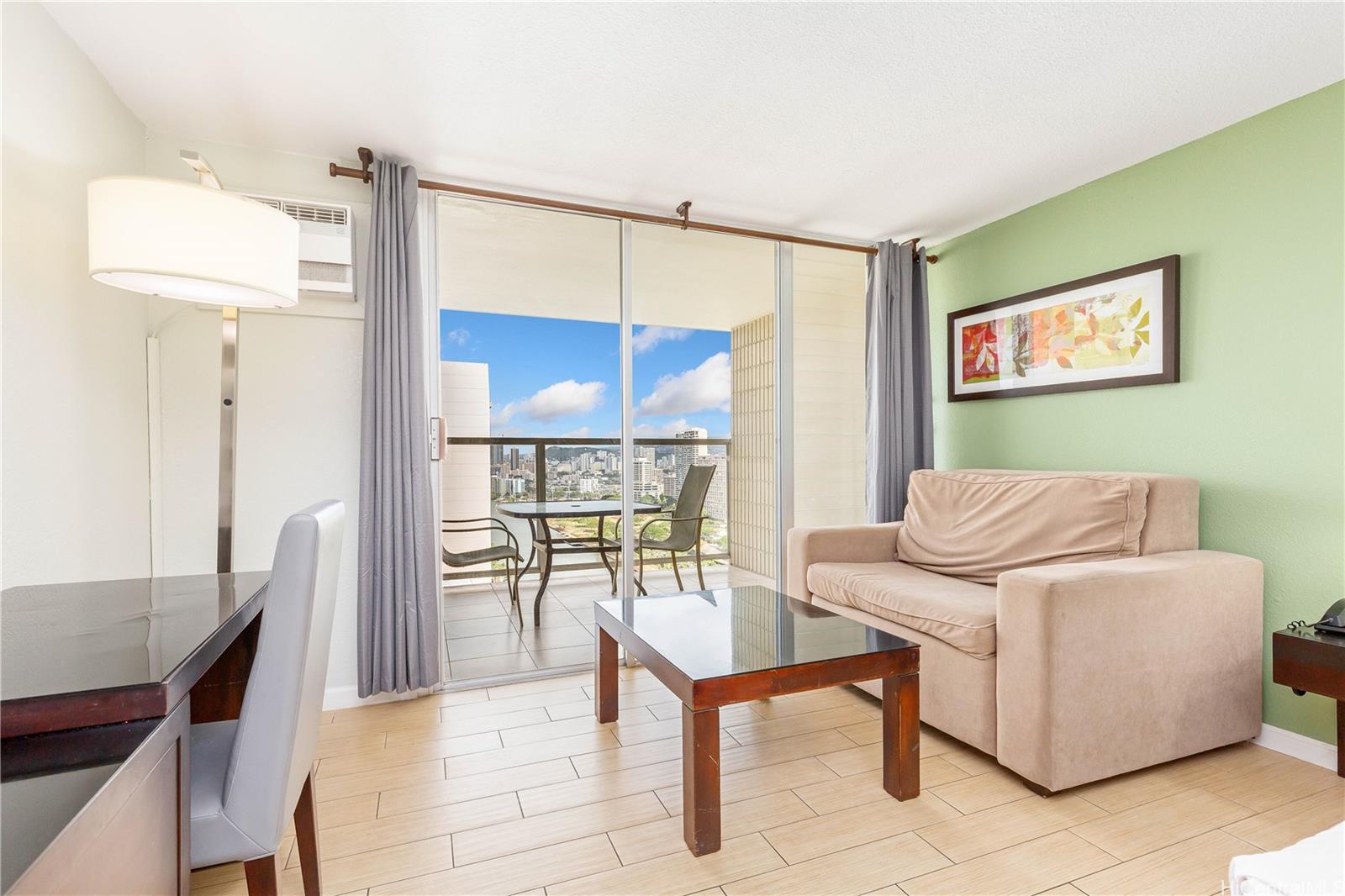 445 Seaside Avenue, Unit 2804 Honolulu, HI 96815 - Photo 4 of 25 a living room with furniture and a table