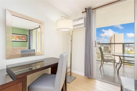a view of a room with furniture and wooden floor