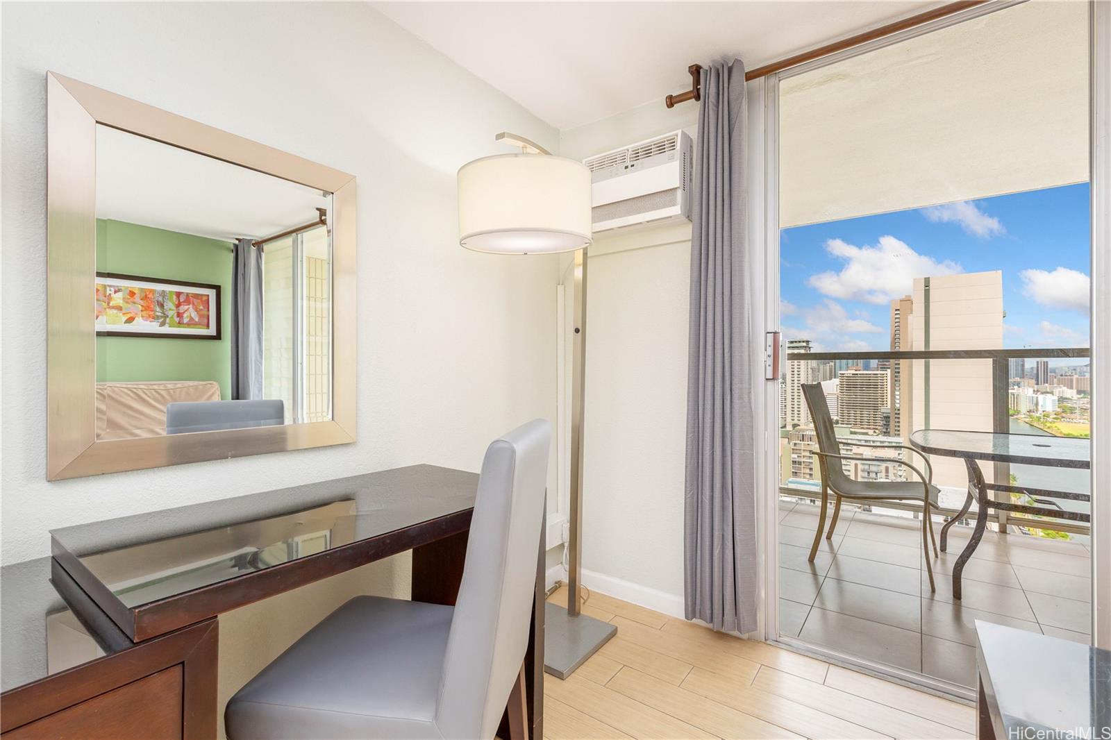 445 Seaside Avenue, Unit 2804 Honolulu, HI 96815 - Photo 5 of 25 a view of a room with furniture and wooden floor