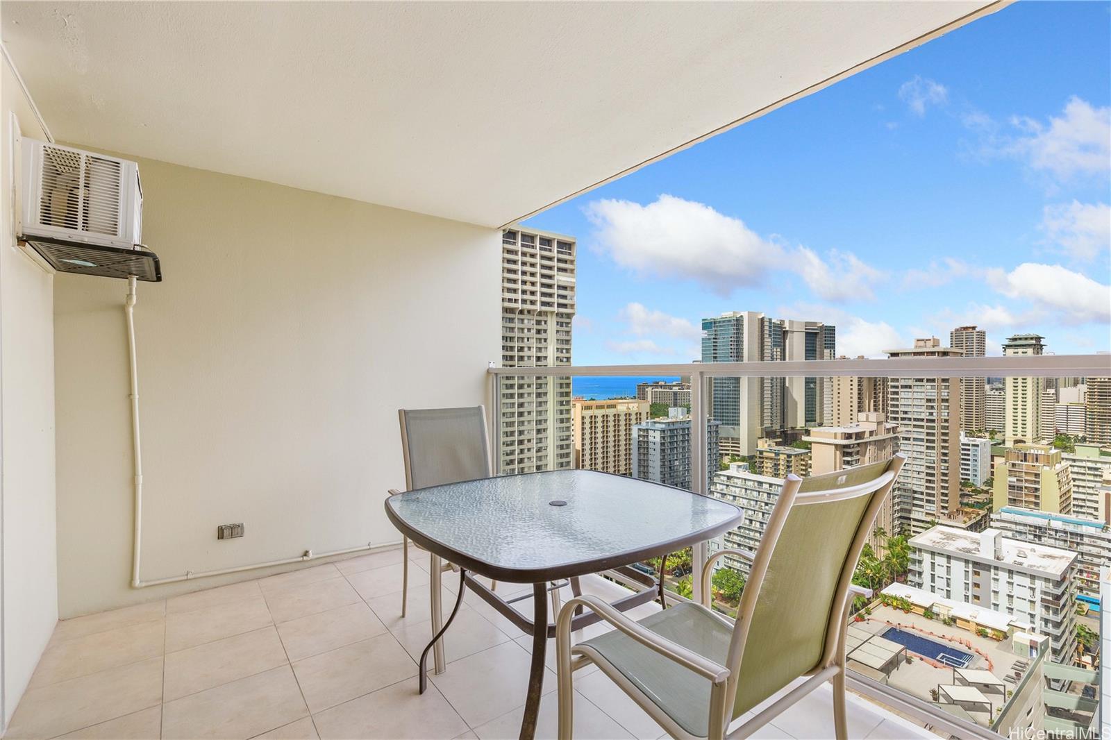 445 Seaside Avenue, Unit 2804 Honolulu, HI 96815 - Photo 7 of 25 a view of a city from a dining room with furniture