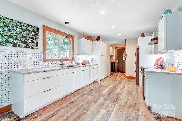 a kitchen with cabinets and stainless steel appliances