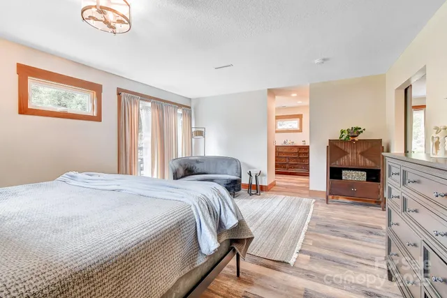 a spacious bedroom with a bed and a couch