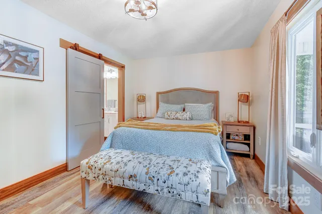 a bedroom with a bed and flat screen tv