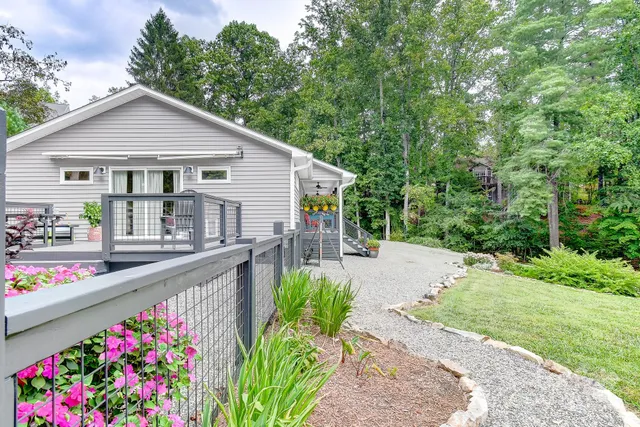 a house view with a garden and deck