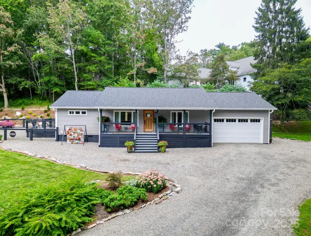 a view of backyard with small cabin and wooden fencing