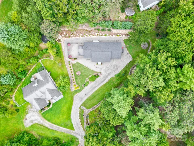 a view of a house with a yard and potted plants
