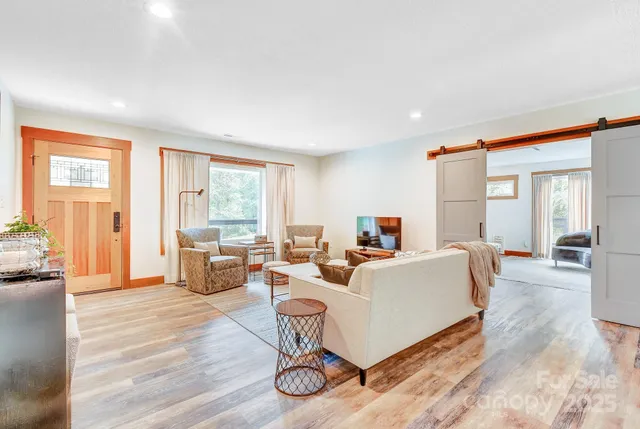 a living room with furniture and a wooden floor