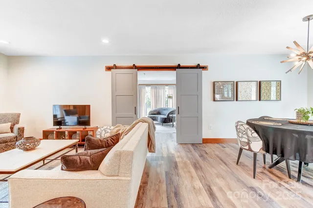 a kitchen with a refrigerator and white cabinets