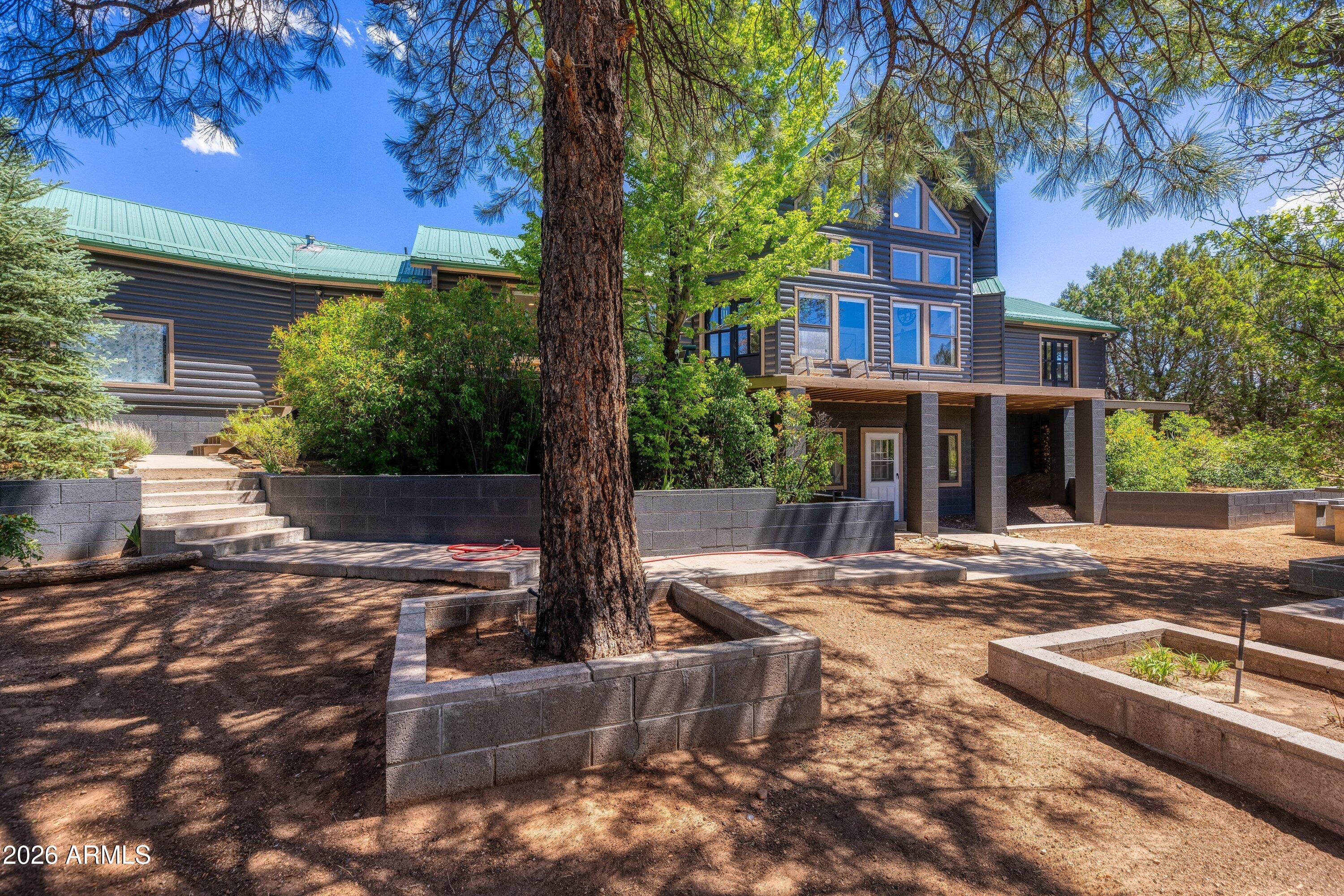 5182 Pinedale Wash Road Pinedale, AZ 85934 - Photo 5 of 54 a front view of a house with garden and trees