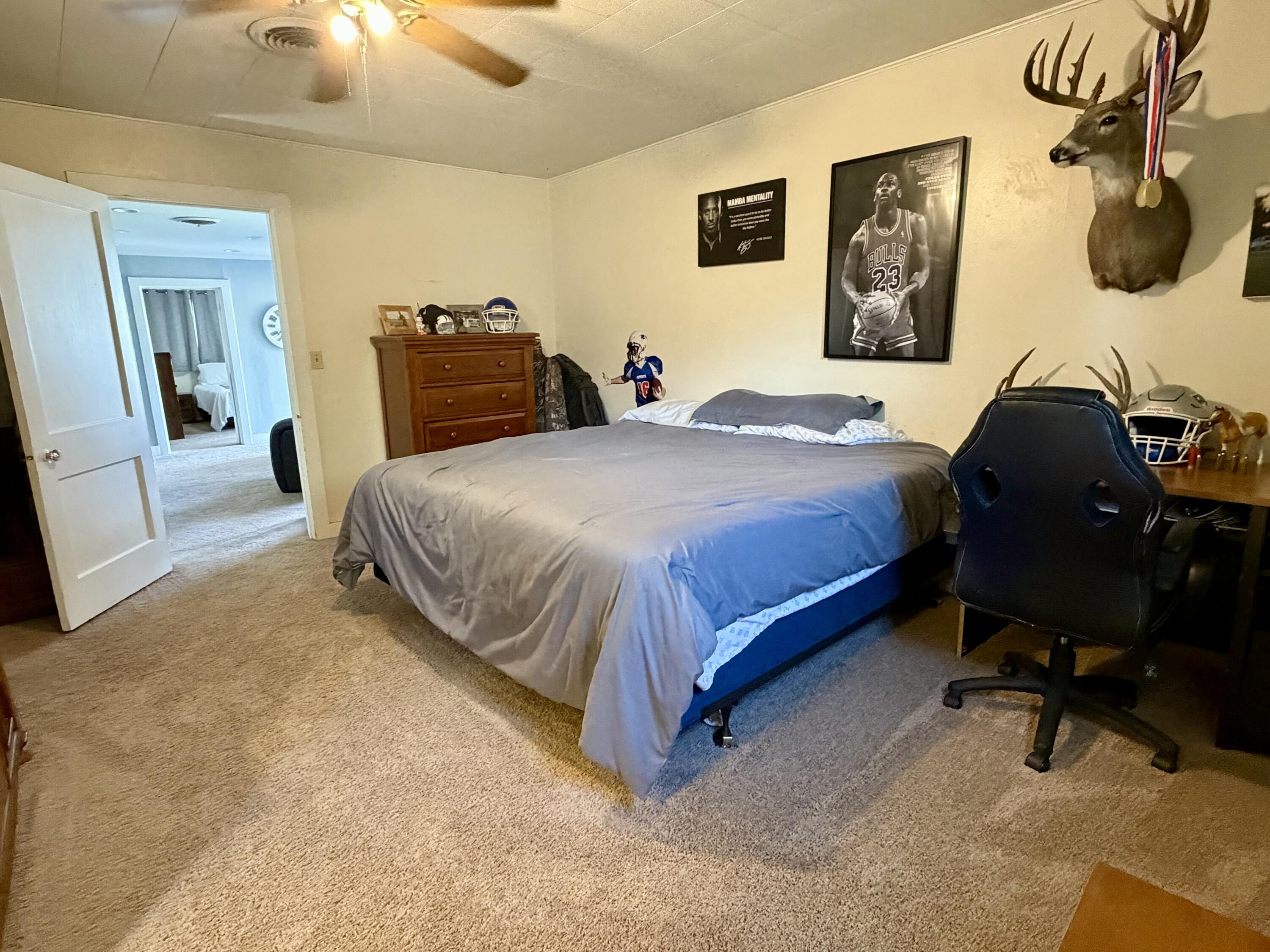 207 2nd Street Quitaque, TX 79255 - Photo 6 of 9 a bedroom with a bed and lamp