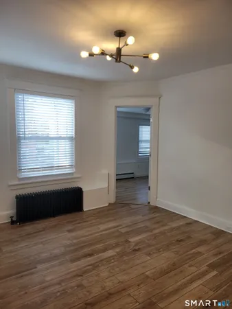 a view of a room window and wooden floor