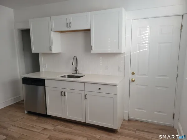 a kitchen with a sink cabinets and a window