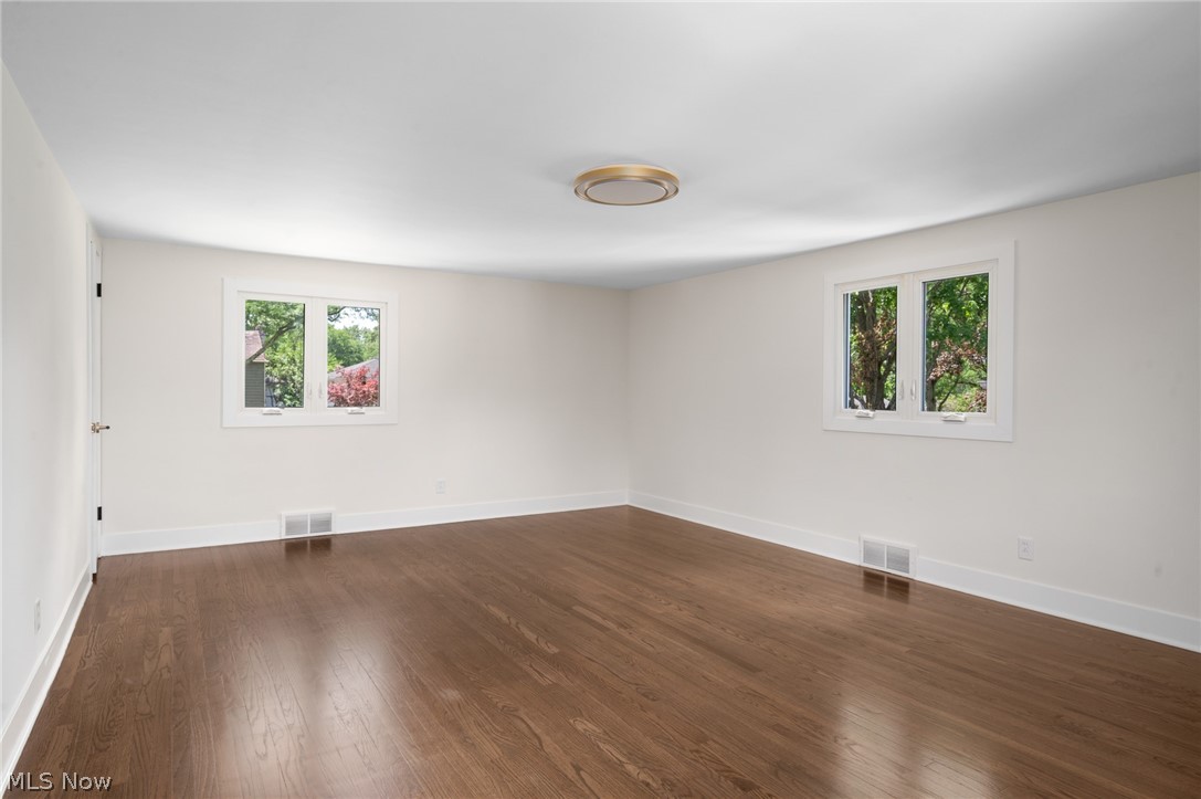 22625 Rye Road Shaker Heights, OH 44122 - Photo 27 of 38 Spacious room featuring wood-finish flooring, white walls, and a contemporary flush-mount ceiling light