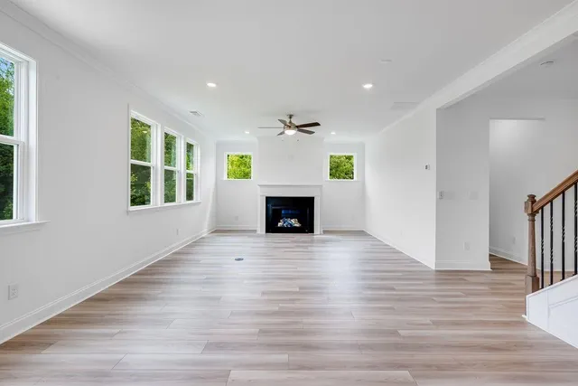 a view of a hallway with wooden floor and closet