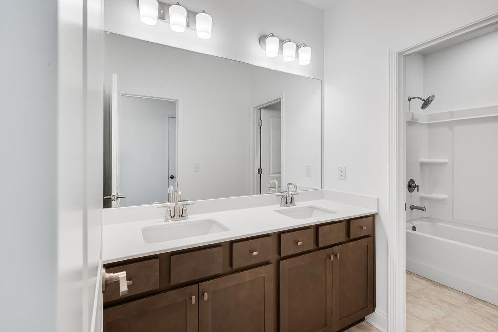3299 Shirecrest Lane Dacula, GA 30019 - Photo 29 of 38 a bathroom with a sink double vanity granite tub and a mirror