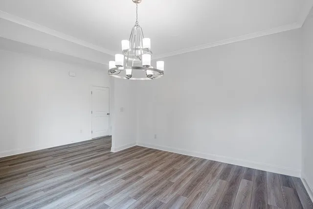 a view of a room with wooden floor staircase and a window