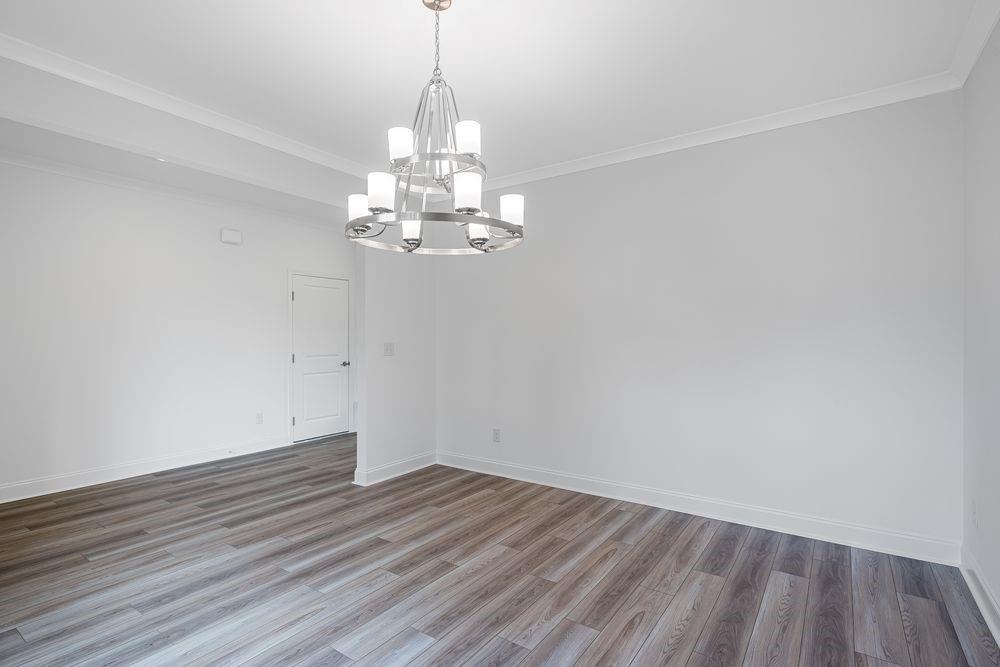 3299 Shirecrest Lane Dacula, GA 30019 - Photo 5 of 38 a view of a room with wooden floor chandelier and window