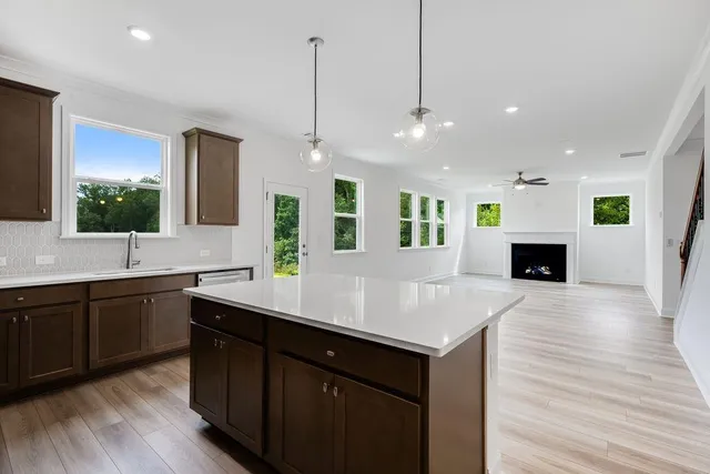 a view of kitchen and hall with wooden floor