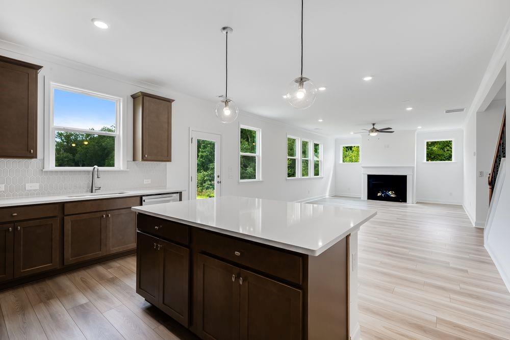 3299 Shirecrest Lane Dacula, GA 30019 - Photo 8 of 38 a kitchen with a sink center island and wooden floor