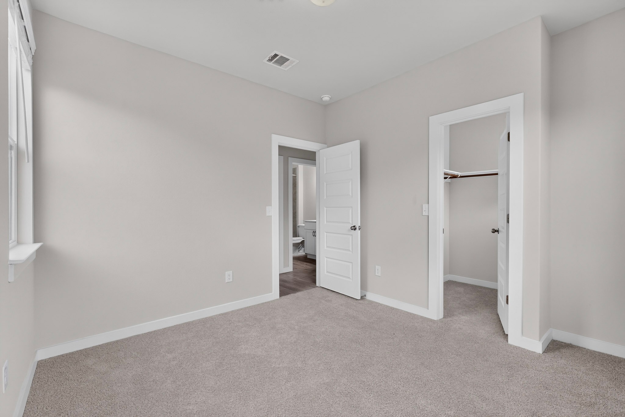 116 Appleberry Lane Elgin, TX 78621 - Photo 28 of 35 A well-lit bedroom features plush carpet and convenient access to a private closet and a bathroom.