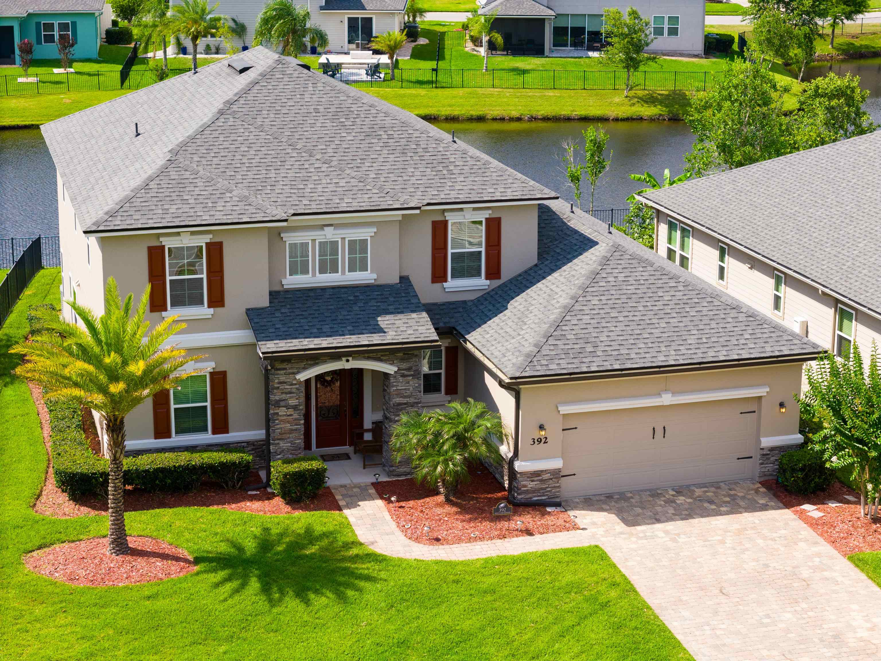 392 Downs Corner Road St. Augustine, FL 32092 - Photo 1 of 55 a aerial view of a house with a yard table and chairs