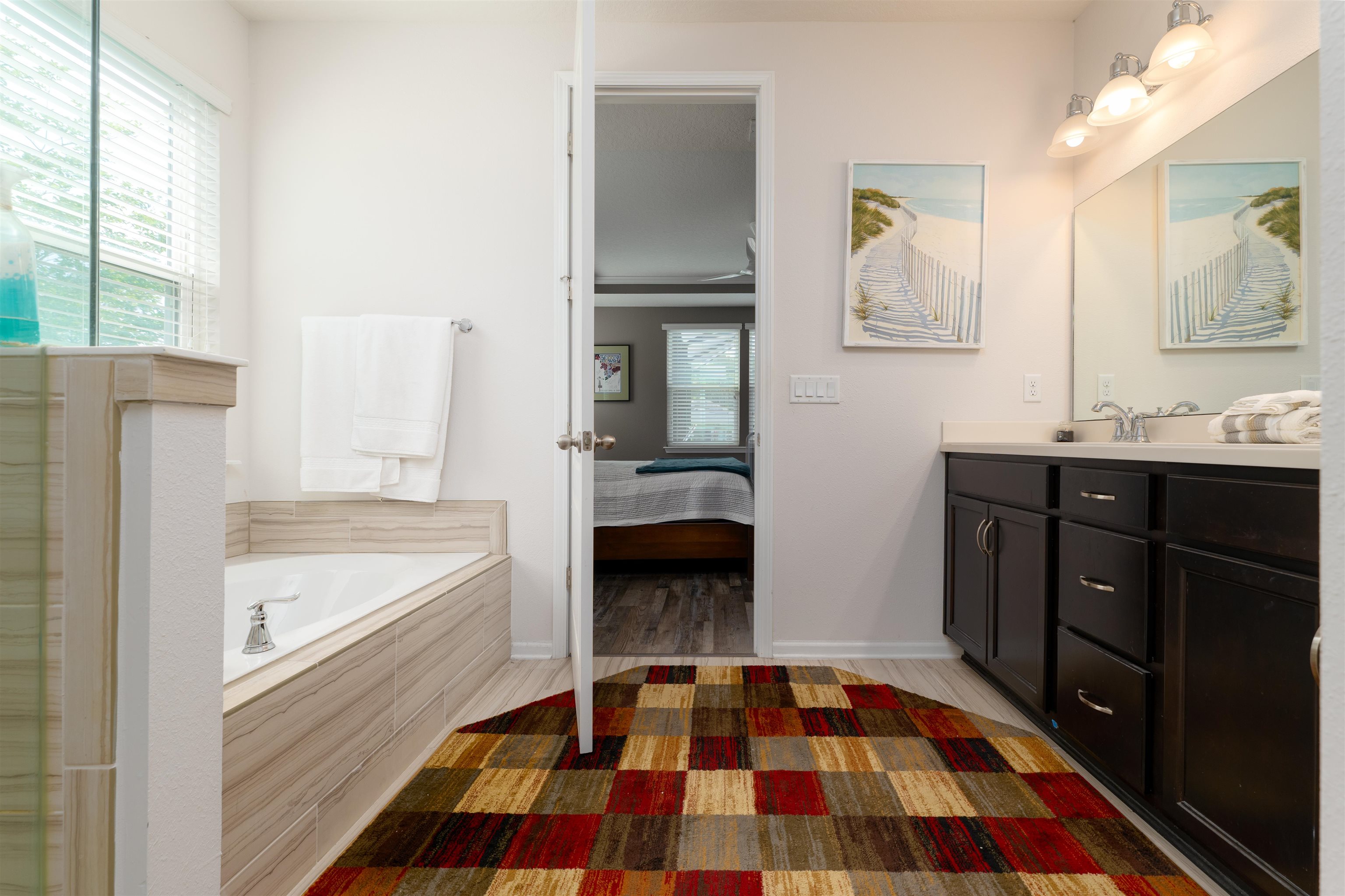 392 Downs Corner Road St. Augustine, FL 32092 - Photo 19 of 55 a bedroom with a bed and a walk in closet with wooden floor