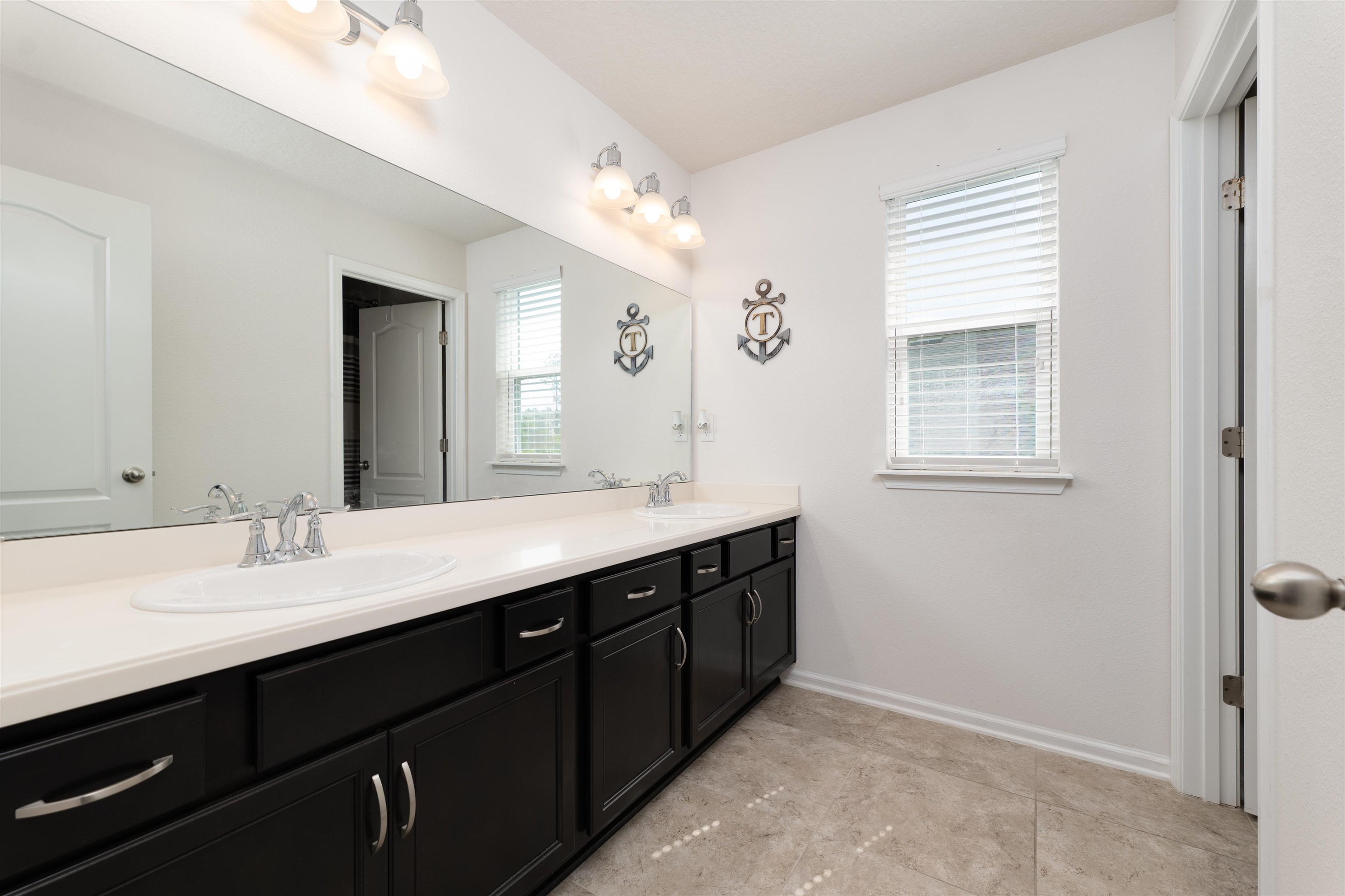 392 Downs Corner Road St. Augustine, FL 32092 - Photo 29 of 55 a bathroom with a double vanity sink a mirror and a shower
